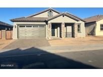 One-story home with gray exterior, two-car garage, and stone accents at 3290 W San Cristobal Rd, San Tan Valley, AZ 85144