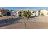 Updated single-story home with desert landscaping and a large front yard at 3350 W Wethersfield Rd, Phoenix, AZ 85029