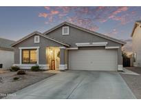 Gray one-story house with a two-car garage and landscaped yard at 37828 N Kyle St, San Tan Valley, AZ 85140