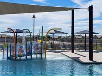 Community spray park with colorful features and shaded seating at 5066 W Hunter Trl, San Tan Valley, AZ 85144