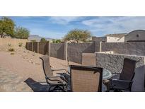 Desert backyard with patio furniture, a built-in grill, and a privacy wall at 10786 E Lazy Doc Ct, Gold Canyon, AZ 85118