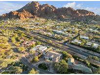 Aerial view of house and neighborhood with mountain backdrop at 4711 E Marston Dr, Paradise Valley, AZ 85253