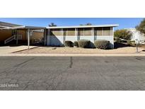 Front view of a mobile home with shrubs at 6960 W Peoria Ave # 16, Peoria, AZ 85345