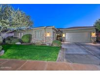 Craftsman style home with stone accents, 3-car garage, and landscaped yard at 12859 W Calle De Baca Dr, Peoria, AZ 85383