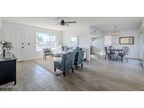 Bright living room features a comfy sofa, two armchairs, and a coffee table at 1436 E Downing St, Mesa, AZ 85203