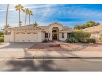 Single-story home with tile roof, two-car garage, and desert landscaping at 14543 W Bison Path, Surprise, AZ 85374