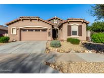Single-story home with two-car garage, landscaping, and desert-inspired exterior at 16468 W Mariposa Grande --, Surprise, AZ 85387