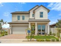 Two-story farmhouse-style home with a gray and white exterior, and a landscaped front yard at 26048 S 229Th Pl, Queen Creek, AZ 85142