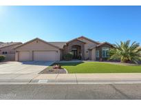 Beautiful single-story home with a three-car garage and lush lawn at 19418 N 86Th Dr, Peoria, AZ 85382