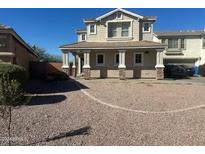 Two-story house with a stone facade and a landscaped front yard at 7402 S 40Th Ln, Phoenix, AZ 85041