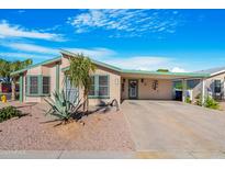 Well-maintained manufactured home with carport and landscaped yard at 8500 E Southern Ave # 567, Mesa, AZ 85209