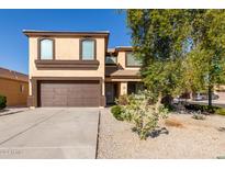 Two-story house with brown garage door and landscaping at 23582 W Wier Ave, Buckeye, AZ 85326