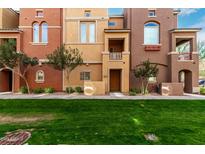 Two-story townhome with grassy yard and neutral color palette at 240 W Juniper Ave # 1058, Gilbert, AZ 85233