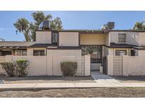 Tan two-story townhome with a gated entry and landscaping at 3120 N 67Th Ln # 47, Phoenix, AZ 85033