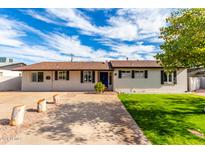 Ranch style home with landscaped lawn and driveway at 4725 N 14Th Ave, Phoenix, AZ 85013