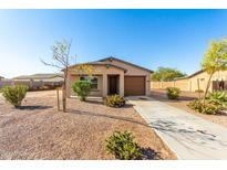 Tan, single-story home with attached garage and desert landscaping at 15580 S Bentley Dr, Arizona City, AZ 85123