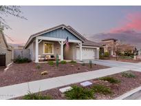 Single-story home with front porch, two-car garage, and landscaped yard at 2744 N Springfield St, Buckeye, AZ 85396