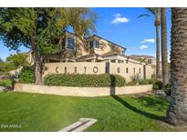 Canyon Gate community exterior featuring Spanish-style architecture and lush landscaping at 7887 N 16Th St # 116, Phoenix, AZ 85020