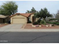 Single-story home with tile roof and landscaped front yard at 2256 E Sherri Dr, Gilbert, AZ 85296