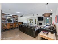 Open living area with modern fireplace and leather sofas at 5239 E Waltann Ln, Scottsdale, AZ 85254