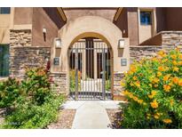 Attractive entry gate with stonework and landscaping, leading to the community at 7027 N Scottsdale Rd # 206, Paradise Valley, AZ 85253