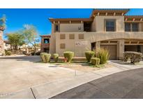 Tan two-story home with attached garage and desert landscaping at 19700 N 76Th St # 2135, Scottsdale, AZ 85255