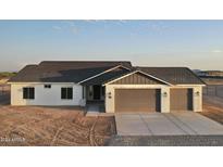 New home exterior with a two car garage and desert landscaping at 20236 W Highland Ave, Litchfield Park, AZ 85340