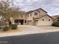 Two-story house with a landscaped yard and attached two-car garage at 22130 N Van Loo Dr, Maricopa, AZ 85138