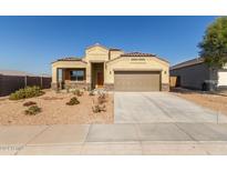 Single-story house with a two-car garage and desert landscaping at 30104 W Indianola Ave, Buckeye, AZ 85396