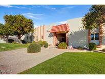 Inviting exterior of a condo building with well-manicured landscaping at 649 S Power Rd # 371, Mesa, AZ 85206