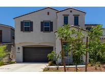 Two-story house with gray siding, brown garage door, and landscaping at 19743 W Exeter Blvd, Buckeye, AZ 85340