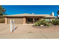 Brick ranch house with a two-car garage and desert landscaping at 4442 E Walatowa St, Phoenix, AZ 85044