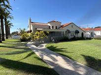 Spanish style home with landscaped lawn, walkway, and palm trees at 901 W Culver St, Phoenix, AZ 85007