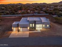 Stunning aerial view of a modern, single-story home with a two-car garage at sunset at 475 W Saddle Mountain Road --, Phoenix, AZ 85086