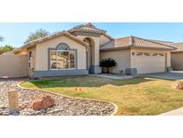 Single-story house with a well-maintained lawn and a two-car garage at 915 W Spur Ave, Gilbert, AZ 85233