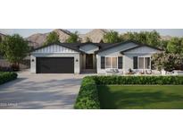Craftsman style home with a two-car garage and landscaped yard at 943 N 97Th Way, Mesa, AZ 85207
