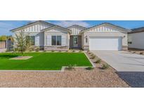 Single-story home with artificial turf lawn and attached garage at 951 N 97Th Way, Mesa, AZ 85207