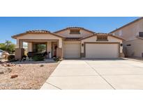 Beautiful one-story home with a two-car garage and landscaped front yard at 10719 E Lupine Ln, Florence, AZ 85132