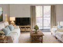 Living room with light colored couches and wooden coffee table at 3434 W Danbury Dr # A204, Phoenix, AZ 85053