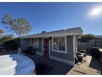 House exterior featuring a gray color scheme and a red door at 8421 S 6Th Ave, Phoenix, AZ 85041