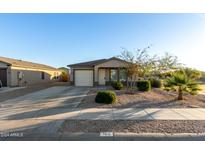 Single-story house with a white garage door and desert landscaping at 165 W Taylor Ave, Coolidge, AZ 85128