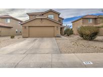 Two-story house with tan exterior, two-car garage, and landscaping at 274 S 18Th St, Coolidge, AZ 85128