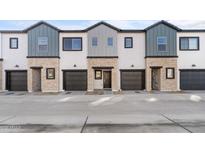 Modern 3-unit townhome building with attached garages and neutral color palette at 2831 W White Feather Ln, Phoenix, AZ 85085