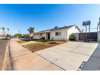 Updated single-level home with a long driveway and a basketball hoop at 6517 W Georgia Ave, Glendale, AZ 85301