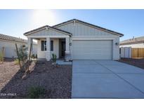 Newly constructed home with two-car garage and desert landscaping at 35595 W Mallorca Ave, Maricopa, AZ 85138