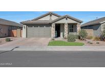 Single-story home with a two-car garage and landscaped front yard at 15072 W Mckinley St, Goodyear, AZ 85338