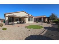 Relaxing backyard with patio, artificial turf, and umbrellas at 17915 W Silver Fox Way, Goodyear, AZ 85338