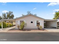 Light pink single-wide mobile home with carport and landscaping at 3330 E Main St # 111, Mesa, AZ 85213