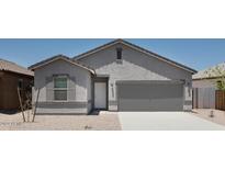 New single-story home with gray exterior, two-car garage, and front landscaping at 47702 W Cansados Rd, Maricopa, AZ 85139