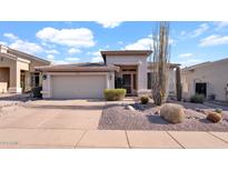 Single-story home with desert landscaping and two-car garage at 22207 N 51St St, Phoenix, AZ 85054